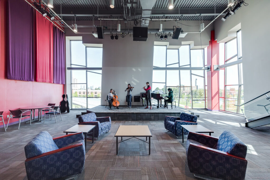 open space room with couches and a stage