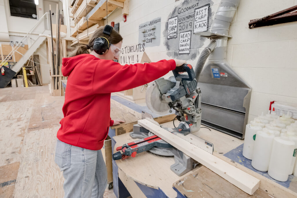 student in a wood shop building an item