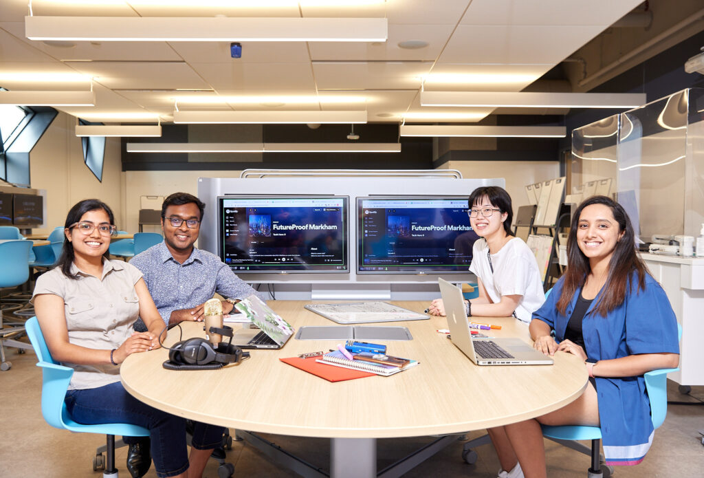 students sitting at a desk working together