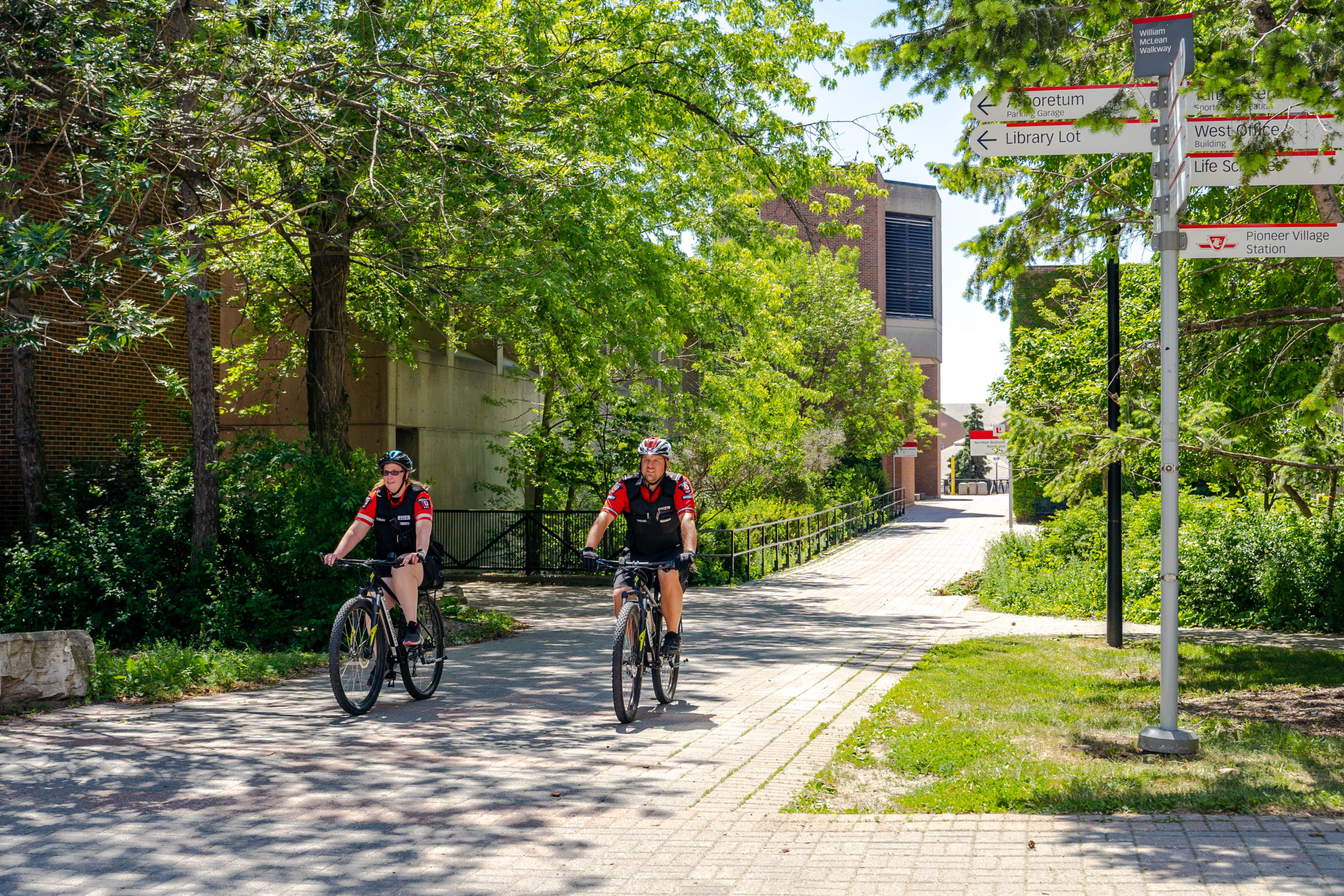 Two York Security staff riding their bicycles while on patrol