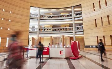 Interior of a university building with students in motion
