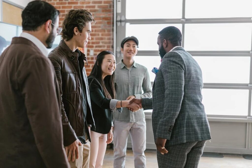 an investor shaking the hand of startup company founders