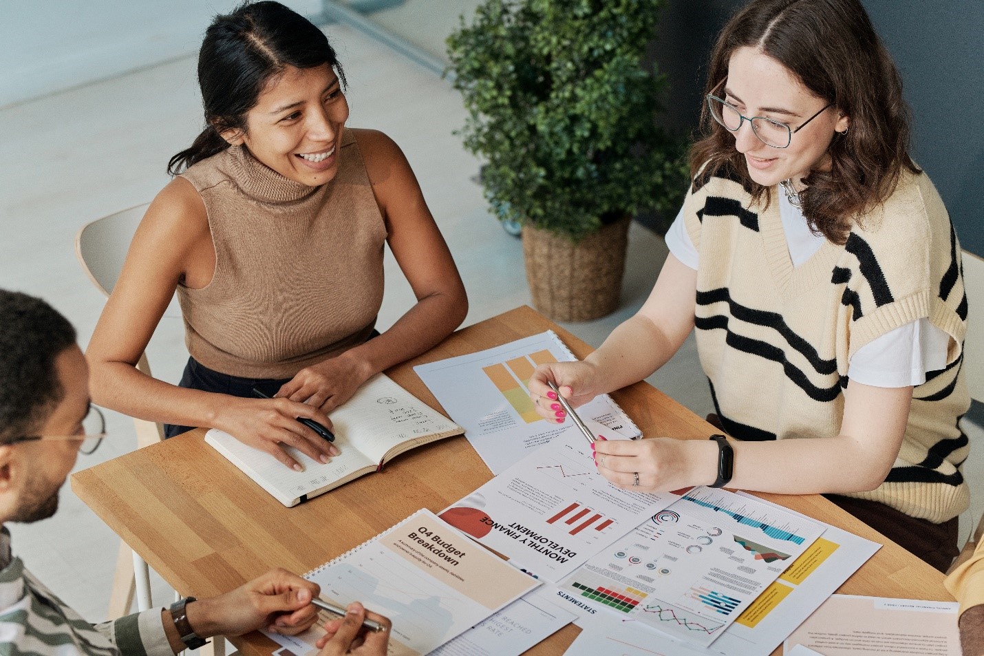 students at a table discussing their work