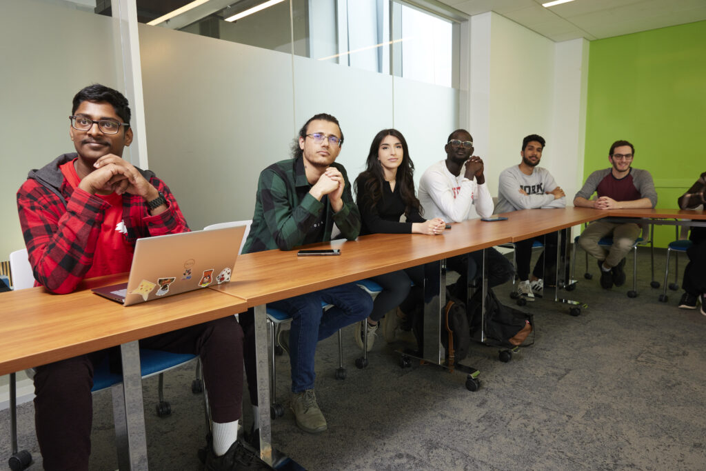 students sitting in a room facing the speaker