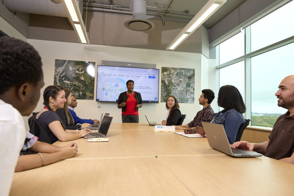 students learning in a small board room